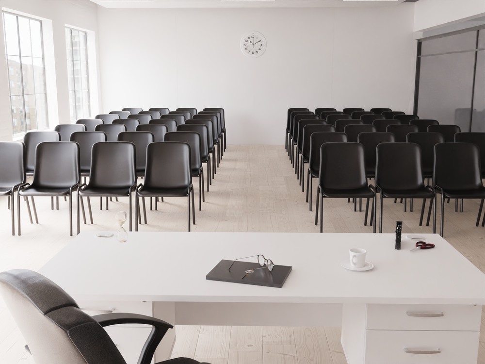 Rows of chairs facing a teaching desk in an education and training space